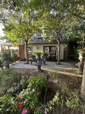 a house with a garden with flowers and trees at Have a nice stay! - Vakantiehuis BijSaar in Noordwijk