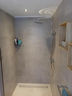 a shower with a glass door in a bathroom at Oudaen 36 in Lelystad