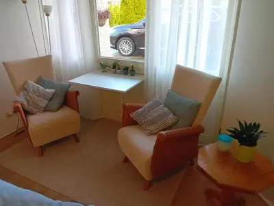 a room with two chairs and a table and a window at Oudaen 36 in Lelystad