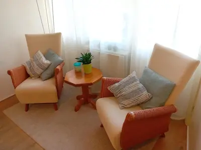a living room with two chairs and a table at Oudaen 36 in Lelystad