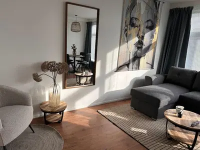 a living room with a couch and a table at Amsterdam Beach Apartment 50 - Basic, incl parking in Zandvoort