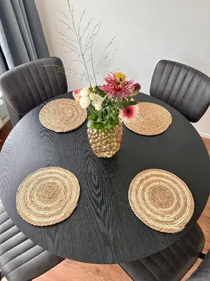 a black table with a vase of flowers on it at Amsterdam Beach Apartment 50 - Basic, incl parking in Zandvoort