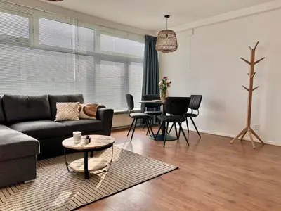 a living room with a couch and a table at Amsterdam Beach Apartment 50 - Basic, incl parking in Zandvoort