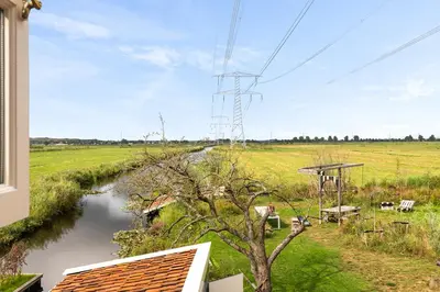 a view of a river from a window of a house at Boutique Hotel Jongwijs Westzaan in Westzaan