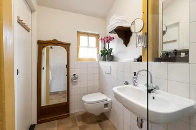 a bathroom with a sink and a toilet and a mirror at Boutique Hotel Jongwijs Westzaan in Westzaan