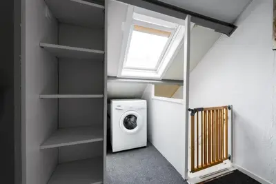 a laundry room with a washing machine and a window at Modern strandhuis 350 m van zee Egmond aan Zee in Egmond aan Zee