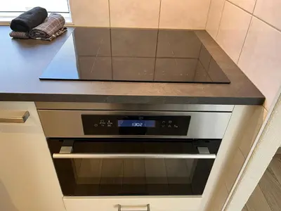a oven in a kitchen with a counter top at Modern strandhuis 350 m van zee Egmond aan Zee in Egmond aan Zee