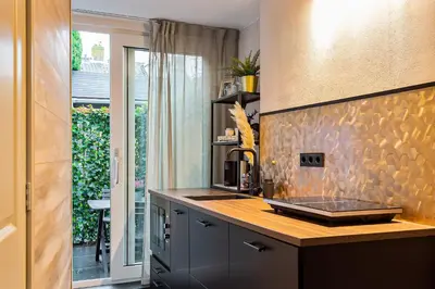 a kitchen with a counter with a stone wall at Loft 29 in Zandvoort