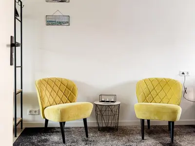 two yellow chairs in a room with a table at M&M Studio's 1 & 2 in Zandvoort