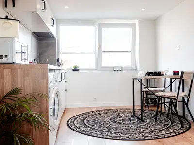 a kitchen with a table and a rug on the floor at M&M Studio's 1 & 2 in Zandvoort