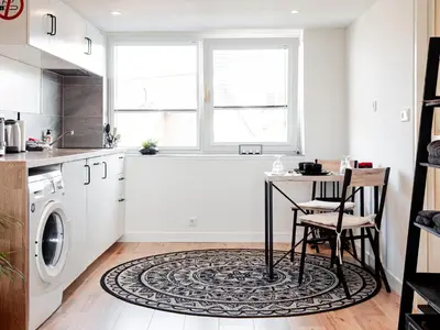 a kitchen with a table and a washing machine at M&M Studio's 1 & 2 in Zandvoort