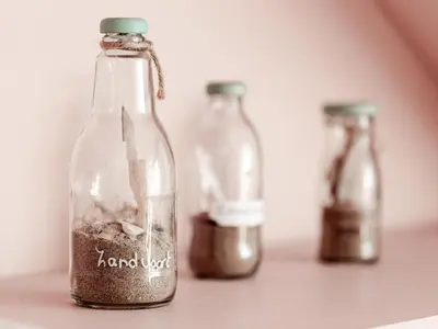 three glass bottles sitting on a table with at M&M Studio's 1 & 2 in Zandvoort