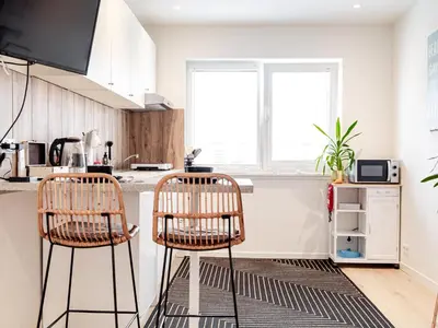 a kitchen with two bar stools in front of a counter at M&M Studio's 1 & 2 in Zandvoort