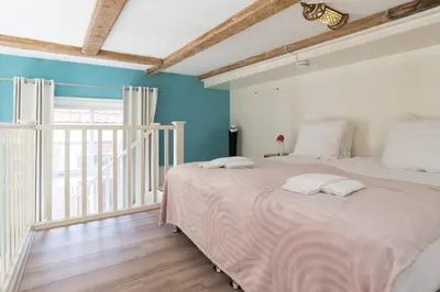 a bedroom with a large bed with blue walls at 1001 Nights Boutique Lofts in Haarlem
