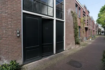 a black garage door on a brick building at 1001 Nights Boutique Lofts in Haarlem