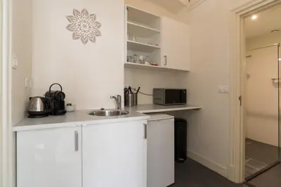 a kitchen with white cabinets and a sink at 1001 Nights Boutique Lofts in Haarlem