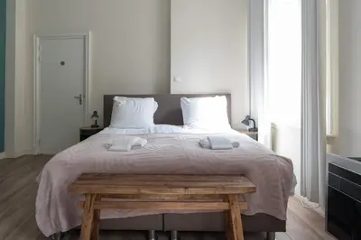 a bedroom with a large bed with two towels on it at 1001 Nights Boutique Lofts in Haarlem