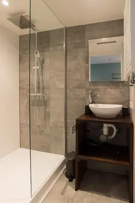 a bathroom with a sink and a shower at 1001 Nights Boutique Lofts in Haarlem