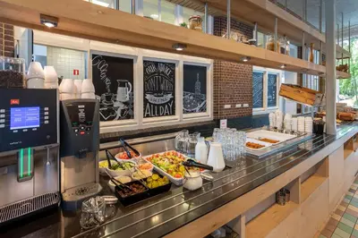 a buffet line in a restaurant with food on display at Stayokay Hostel Soest in Soest