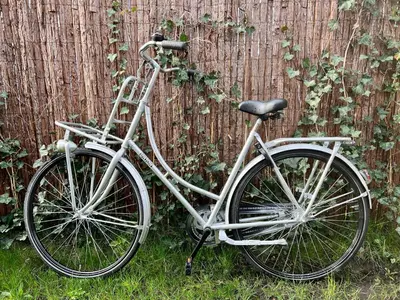 a white bike parked next to a fence at NEW - The Surf Shack - on a lake near Amsterdam! in Vinkeveen