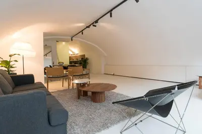 a living room with a couch and a table at Wellness Apartment on the Wharf Utrecht in Utrecht