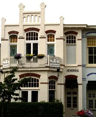 a large white building with a balcony at Hendrika Apartments in Zandvoort