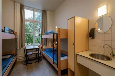 a small room with bunk beds and a sink at Stayokay Hostel Utrecht - Bunnik in Bunnik
