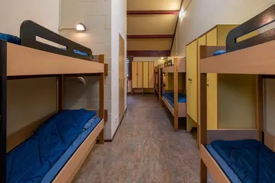 a corridor of a dorm room with bunk beds at Stayokay Hostel Utrecht - Bunnik in Bunnik