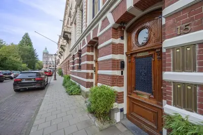 a building with a clock on the side of it at Park Mansion Hotel in Amsterdam