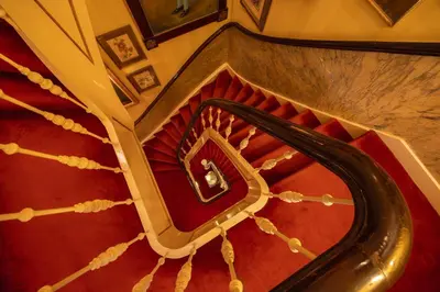 an overhead view of a spiral staircase in a building at Park Mansion Hotel in Amsterdam