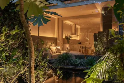 a hotel room with a bed and plants at Park Mansion Hotel in Amsterdam