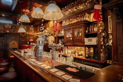 a bar with a counter with glasses on it at The Old Nickel Hotel in Amsterdam