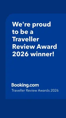 a blue sign that says were proud to be a traveller reviewagency winner at Vakantiebungalow in Riviera Maison stijl nabij zee en strand, bos en duin in Warmenhuizen