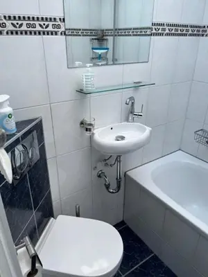a bathroom with a toilet and a sink at Vakantiebungalow in Riviera Maison stijl nabij zee en strand, bos en duin in Warmenhuizen