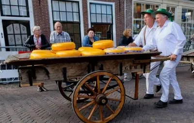 a group of people standing around a cart of cheese at Vakantiebungalow in Riviera Maison stijl nabij zee en strand, bos en duin in Warmenhuizen
