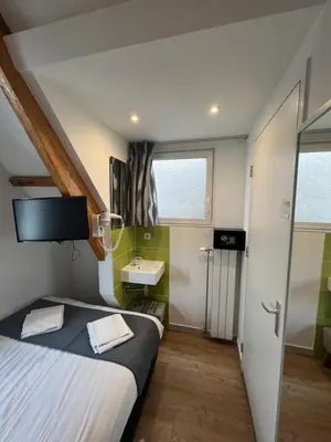 a hotel room with a bed and a sink at MAX Hotel Amsterdam in Amsterdam