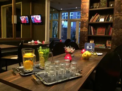 a table in a restaurant with glasses on it at Apple Inn Hotel in Amsterdam