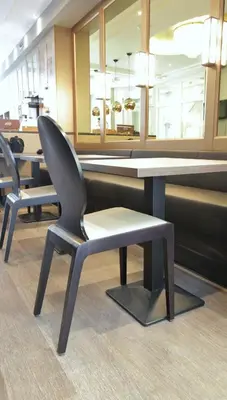 a chair and a table in a waiting room at Apple Inn Hotel in Amsterdam