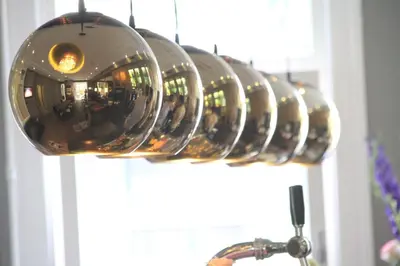 a row of wine glasses hanging from a rack at Apple Inn Hotel in Amsterdam
