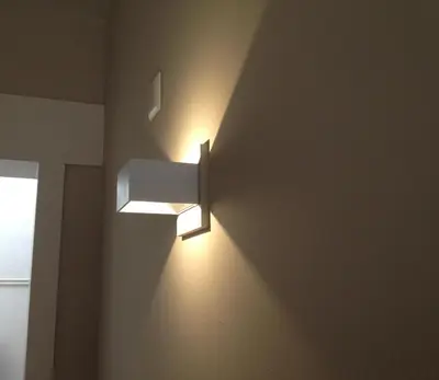 a bathroom with a light on the wall at Apple Inn Hotel in Amsterdam