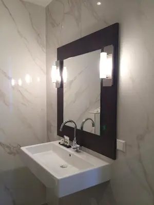 a bathroom with a white sink and a mirror at Apple Inn Hotel in Amsterdam