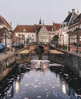 a river in the middle of a city with buildings at Urban stay Zuid in Amersfoort