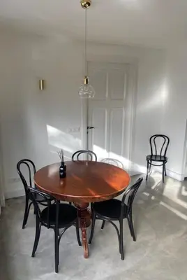 a wooden table and chairs in a room at Urban stay Zuid in Amersfoort