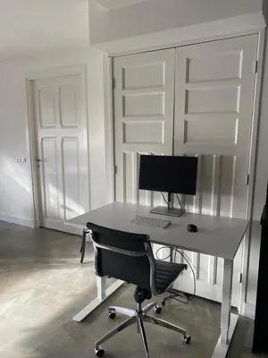 a desk with a computer and a chair in a room at Urban stay Zuid in Amersfoort