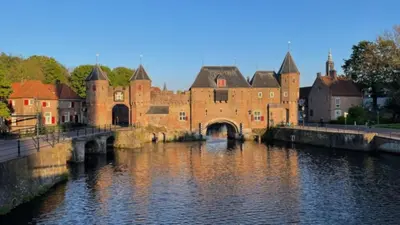 a large castle with a bridge over a river at Urban stay Zuid in Amersfoort