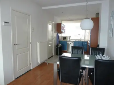 a kitchen and dining room with a table and chairs at Appartement 
