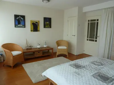 a bedroom with a bed and a table and chairs at Appartement 