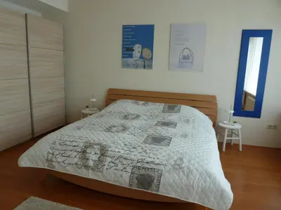 a bedroom with a bed with a white comforter at Appartement 