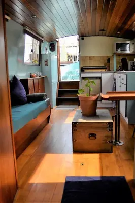 a small kitchen and living room in a rv at Floating B&B Amsterdam in Amsterdam