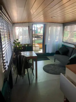 a living room with a table and a couch at Floating B&B Amsterdam in Amsterdam
